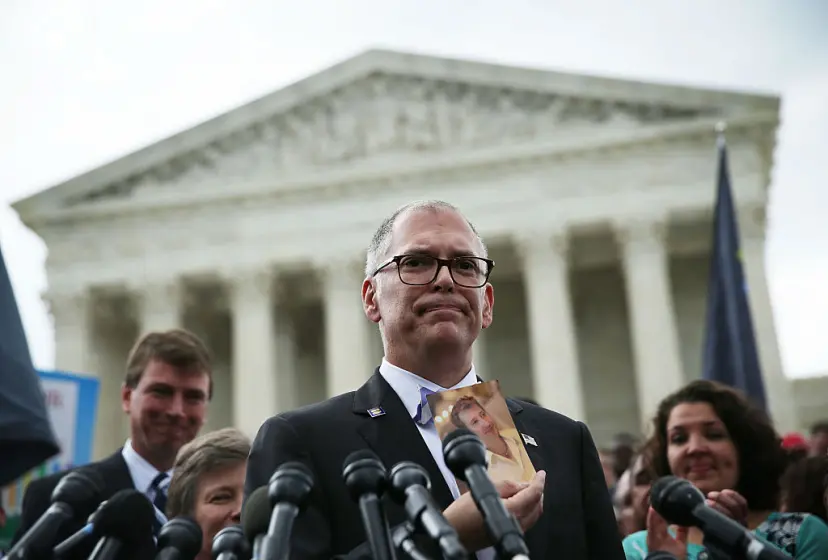 Plaintiff Jim Obergefell holds a photo of his late husband John Arthur as he speaks to members of the media after the U.S. Supreme Court handed down a ruling regarding same-sex marriage on June 26, 2015 in Washington, DC.Alex Wong—Getty Images